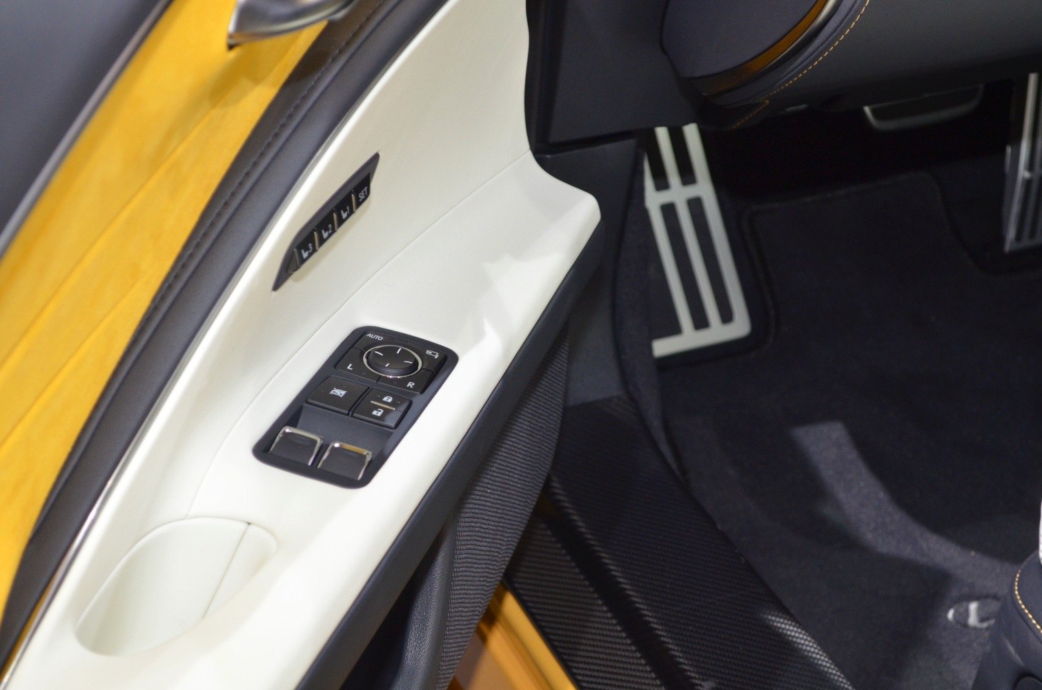 Car interior door panel with memory seat buttons and foot pedals