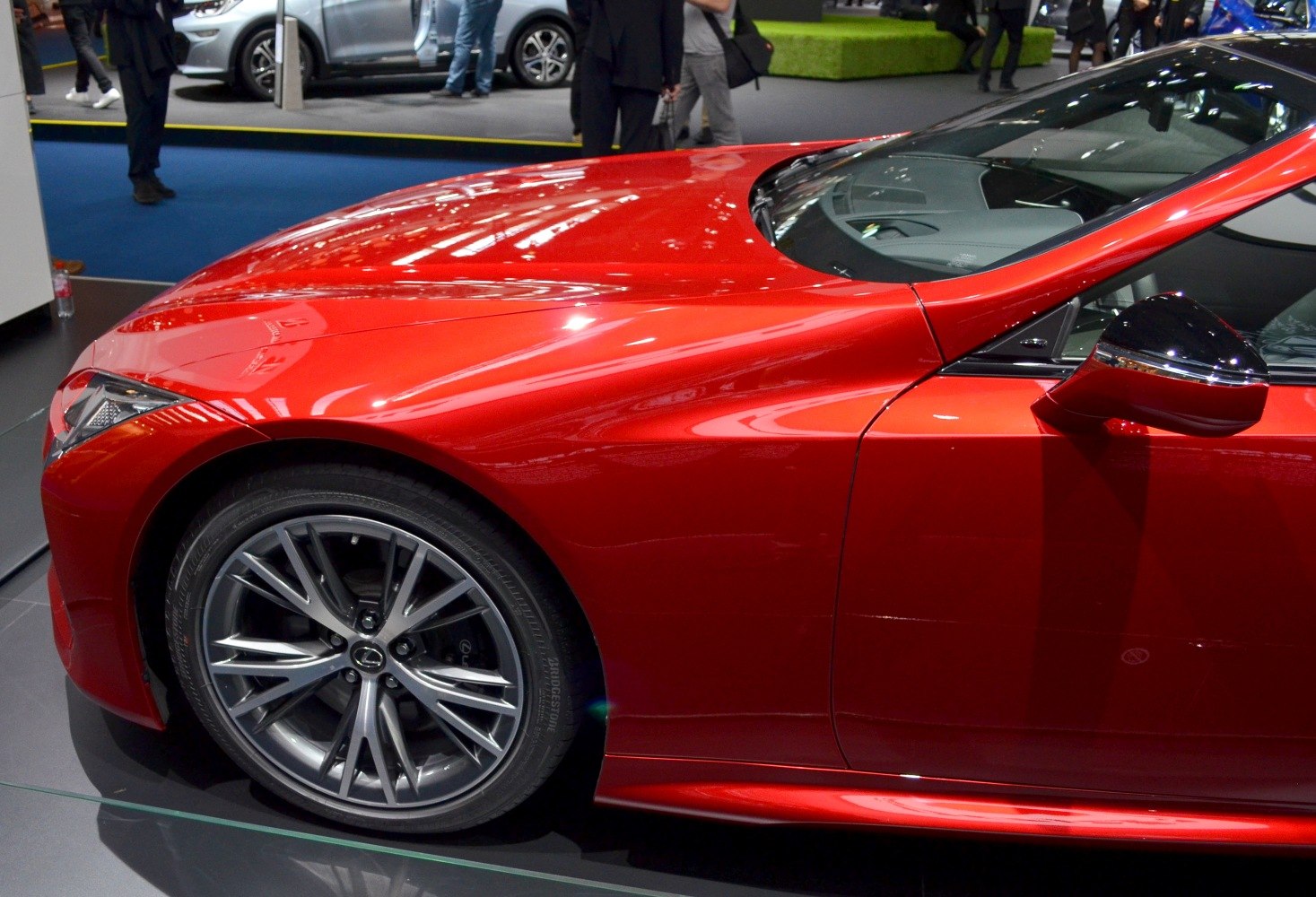 Close-up of front quarter showing alloy wheel and smooth aerodynamic body lines