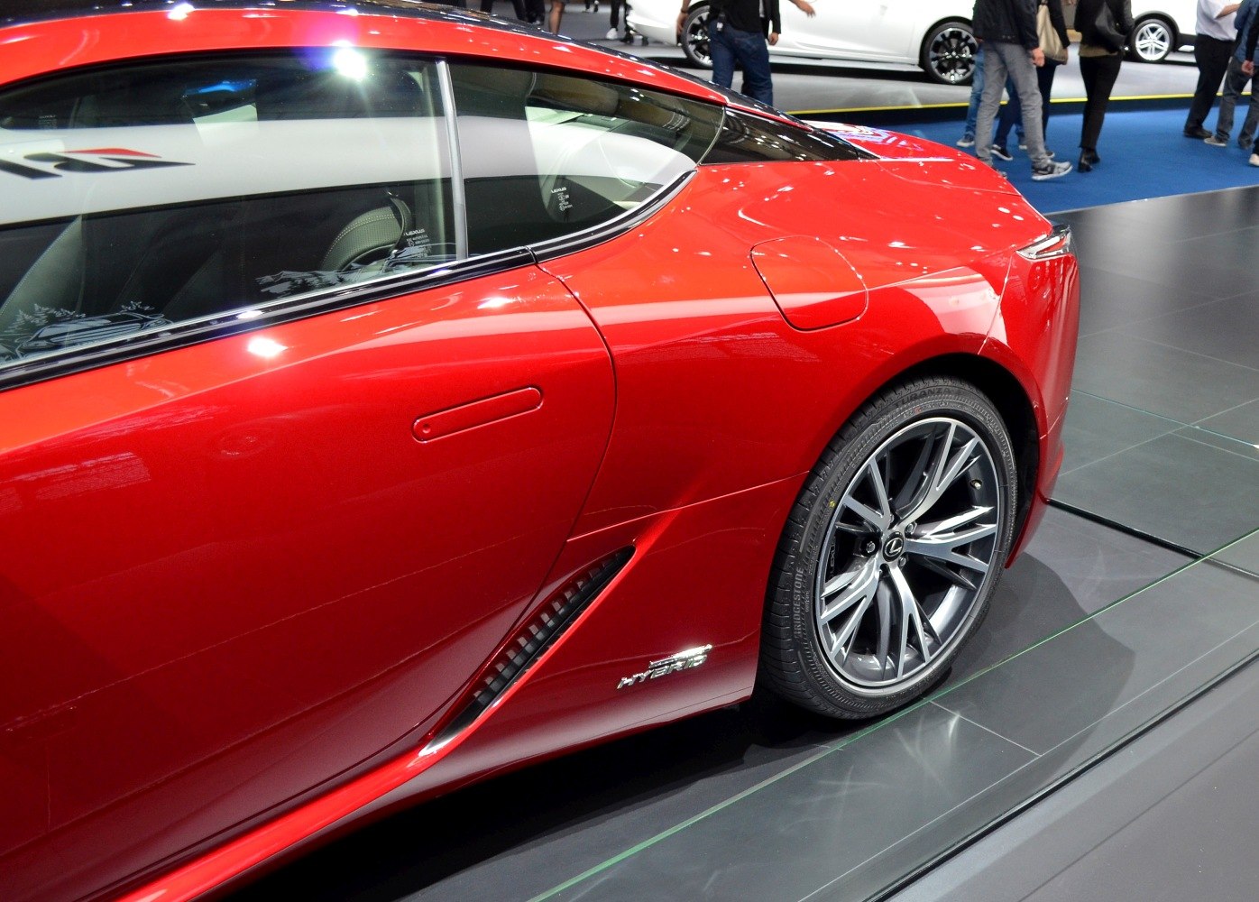 Rear side and alloy wheel detail with hybrid badge on a red sports coupe