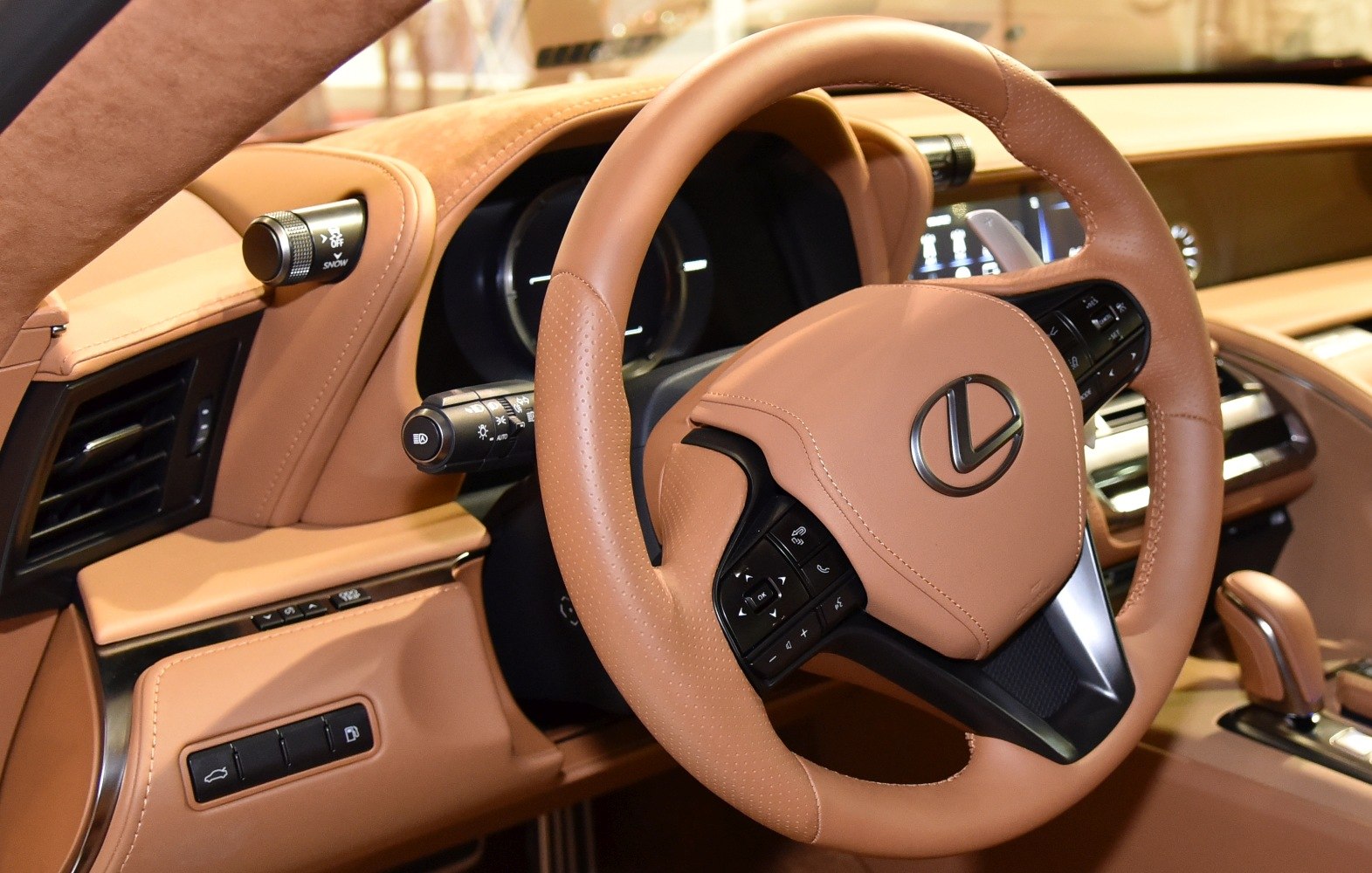 Tan leather steering wheel with integrated controls and luxury dashboard