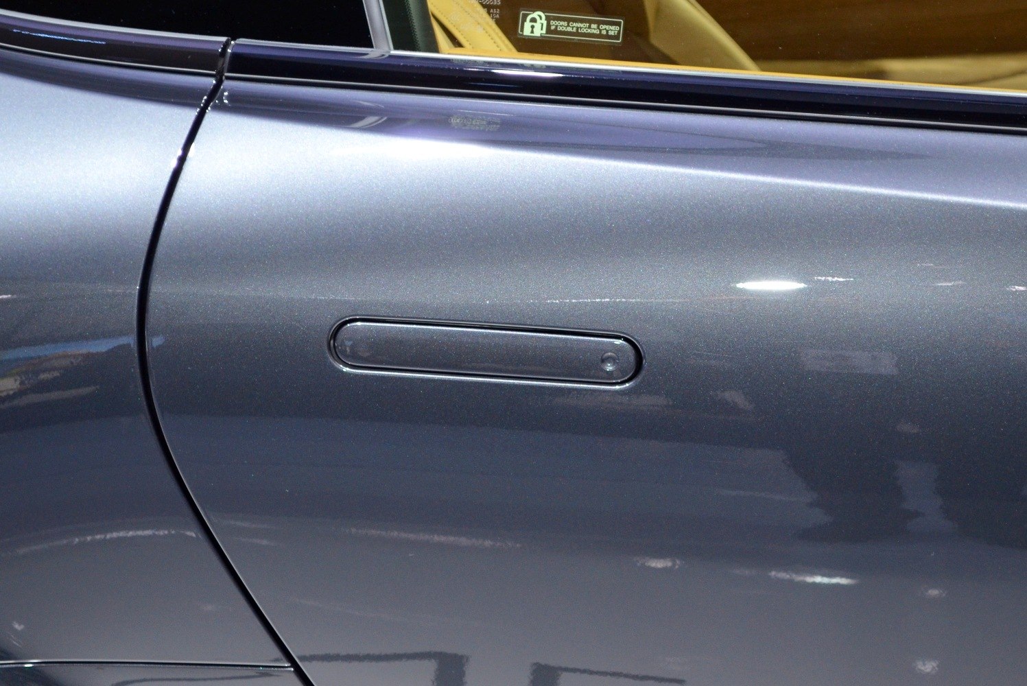 Close-up of flush door handle on smooth car door surface