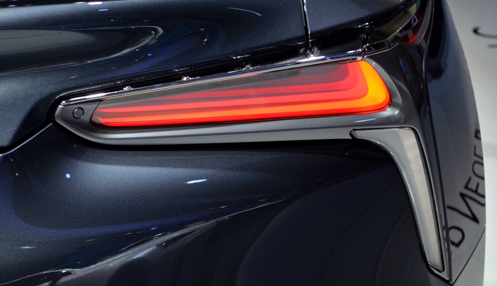 Close-up of modern rear LED tail light with sleek angular design.
