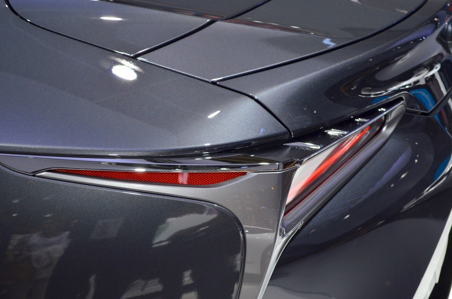 Close-up of sleek rear light and panel with red reflector