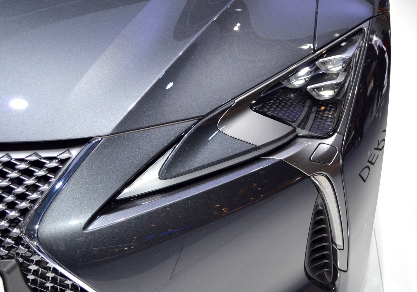 Sharp headlights and distinctive front grille in close-up view