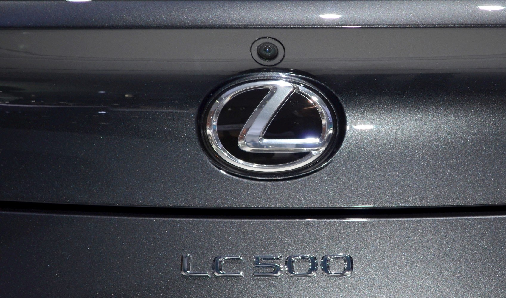 Rear Lexus emblem with camera and LC 500 badge on metallic surface