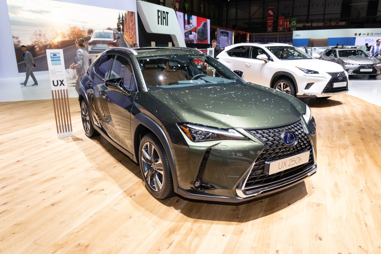 Front view of a green luxury crossover with spindle grille and LED headlights