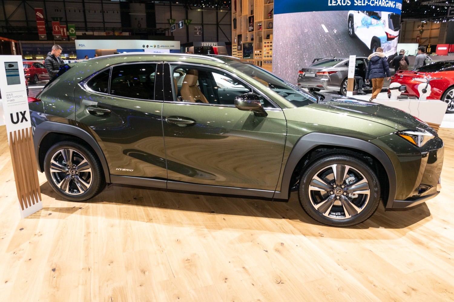 Side view of metallic green hybrid compact SUV with alloy wheels