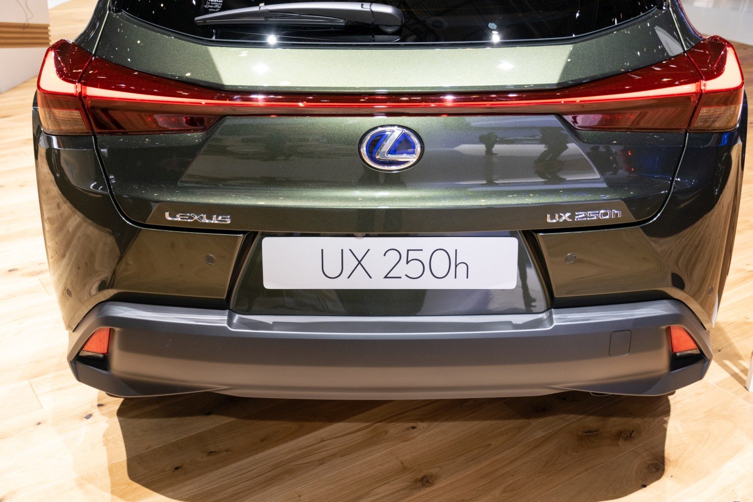 Rear view of modern vehicle with continuous LED taillight and hybrid badging