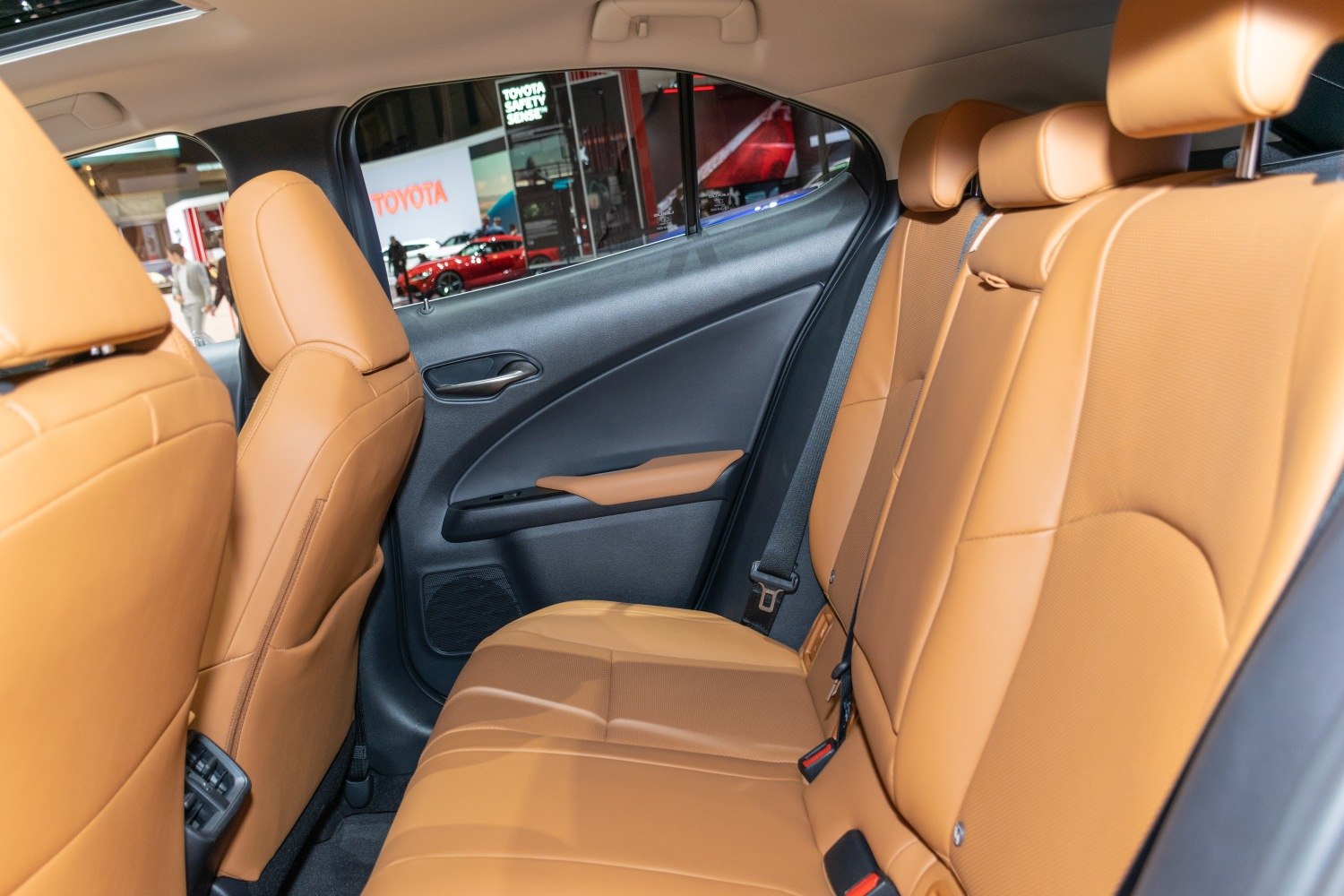 Rear interior seating with tan leather upholstery and door panel