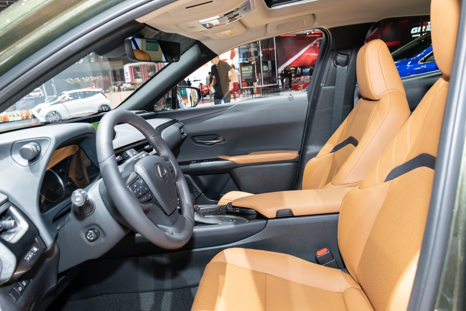 Luxury tan leather seats and modern dashboard with steering wheel