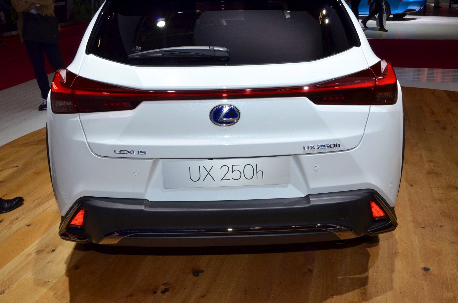 Rear view with distinctive tail lights and Lexus badge on hybrid SUV.