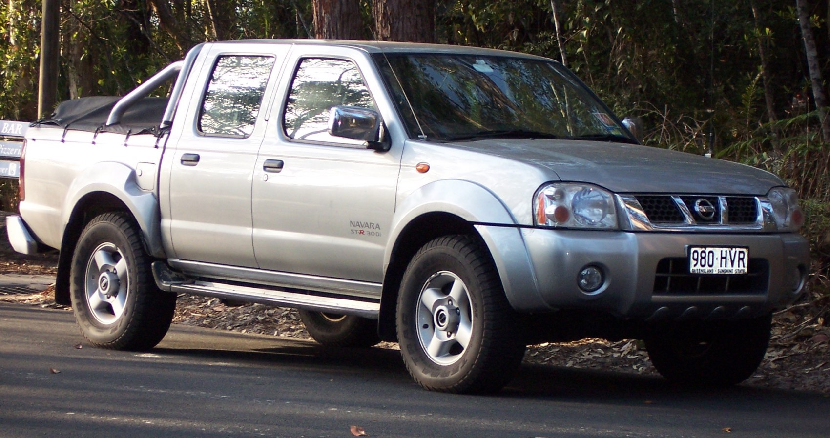 Double cab pickup truck with off-road tires and covered bed