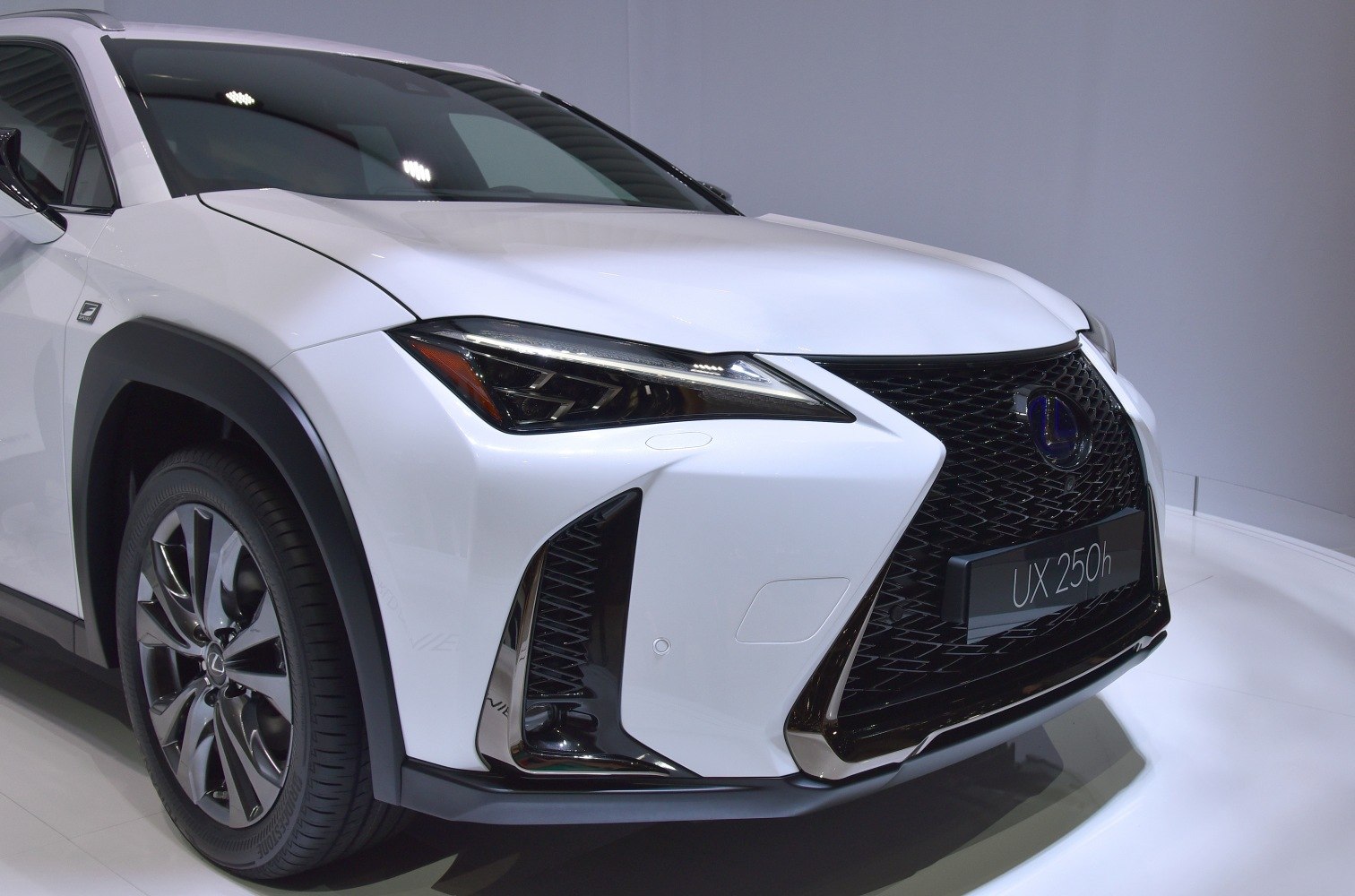 Close-up of front spindle grille and LED headlights with alloy wheel.