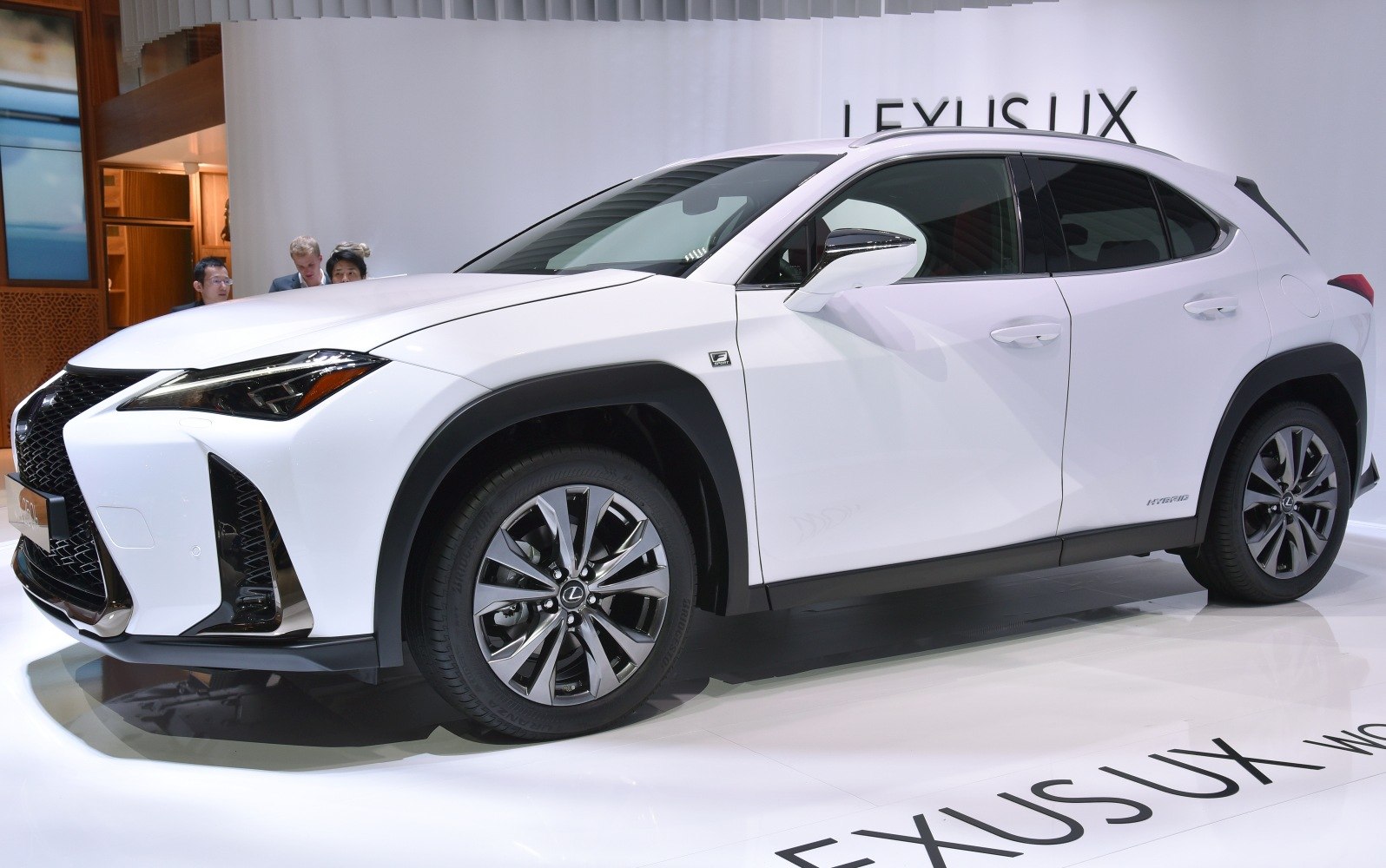 Front and side view of a compact luxury hybrid SUV with sharp headlights and modern styling