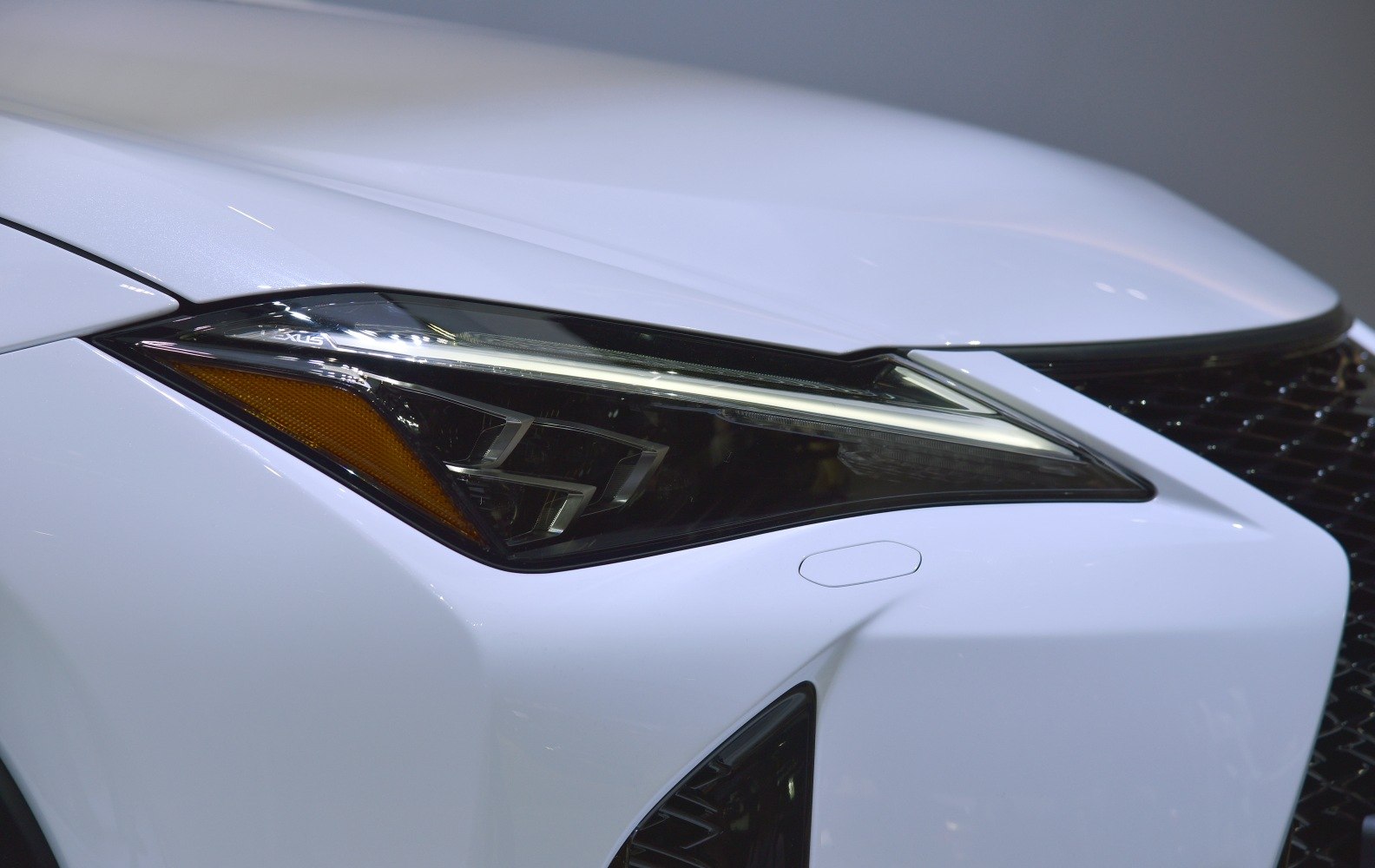 Close-up of sleek LED headlight and front grille details