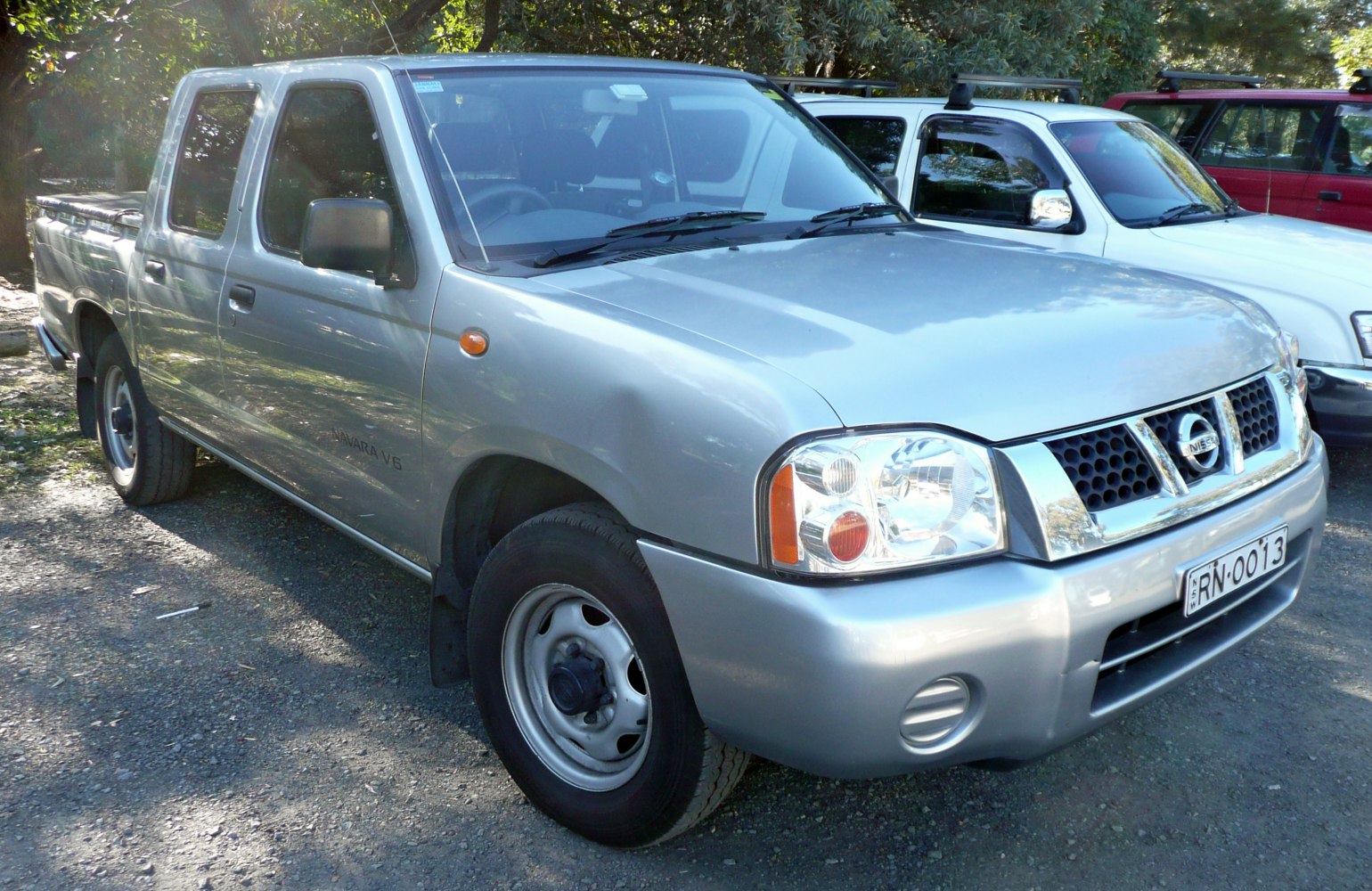Front-side view of a dual cab pickup truck with silver paint and steel wheels