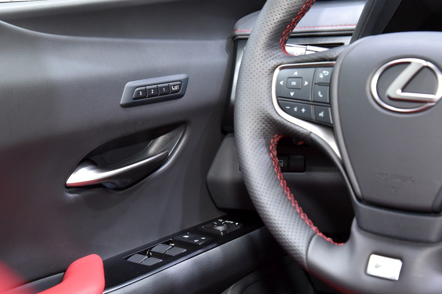 Interior door controls and stitched steering wheel detail
