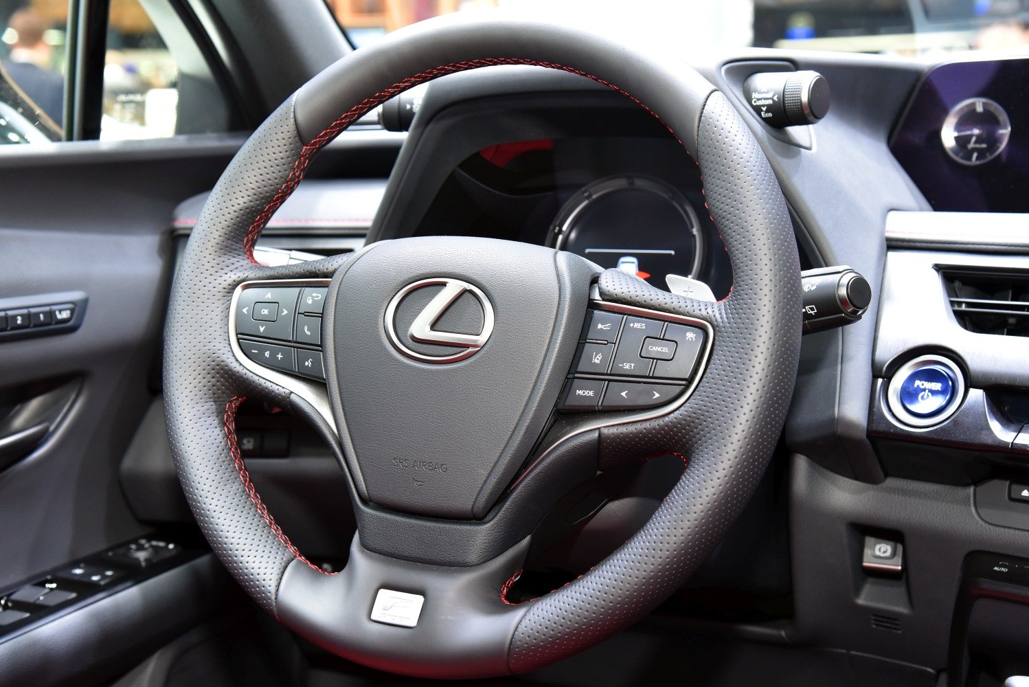 Steering wheel with control buttons and dashboard elements