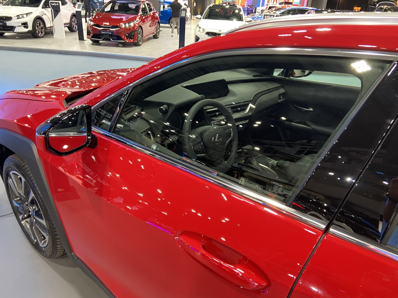Red SUV side profile with detailed interior, steering wheel, and dashboard