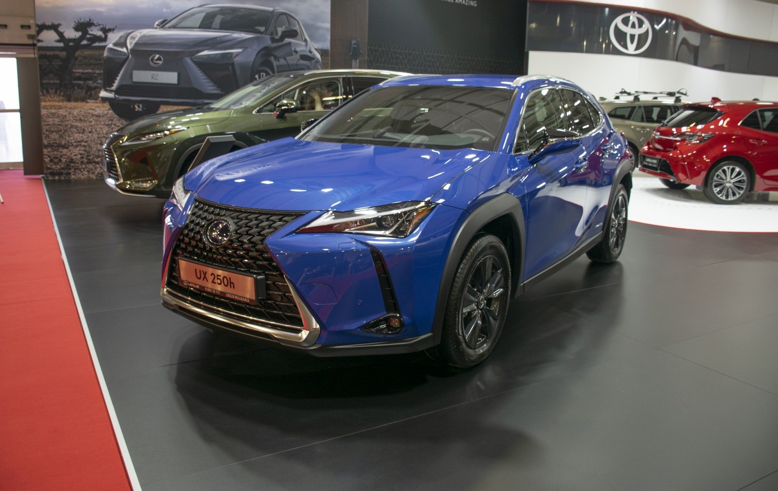 Front view of blue hybrid compact SUV with mesh grille and LED headlights