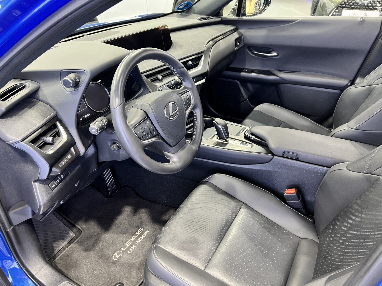 Dashboard, steering wheel, center console, and leather seats inside a modern vehicle interior
