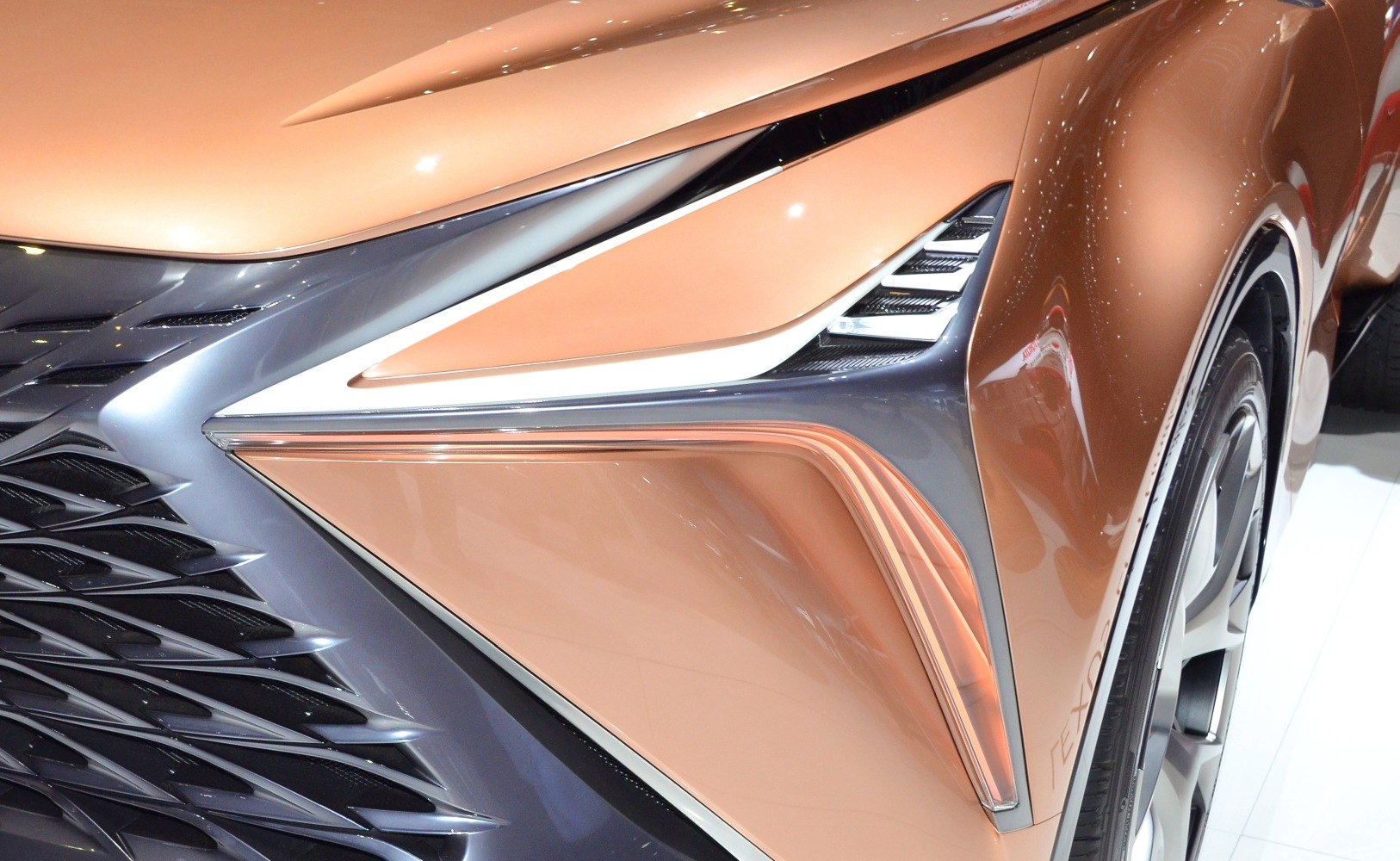 Close-up of futuristic front headlight and intricate grille design