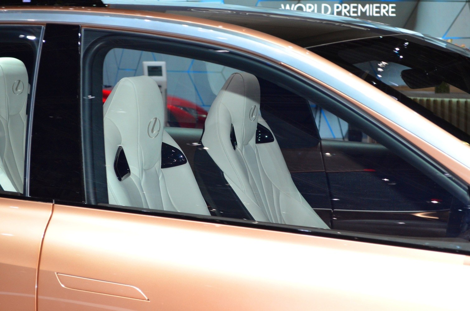 White sport seats with embossed logo inside luxury vehicle.