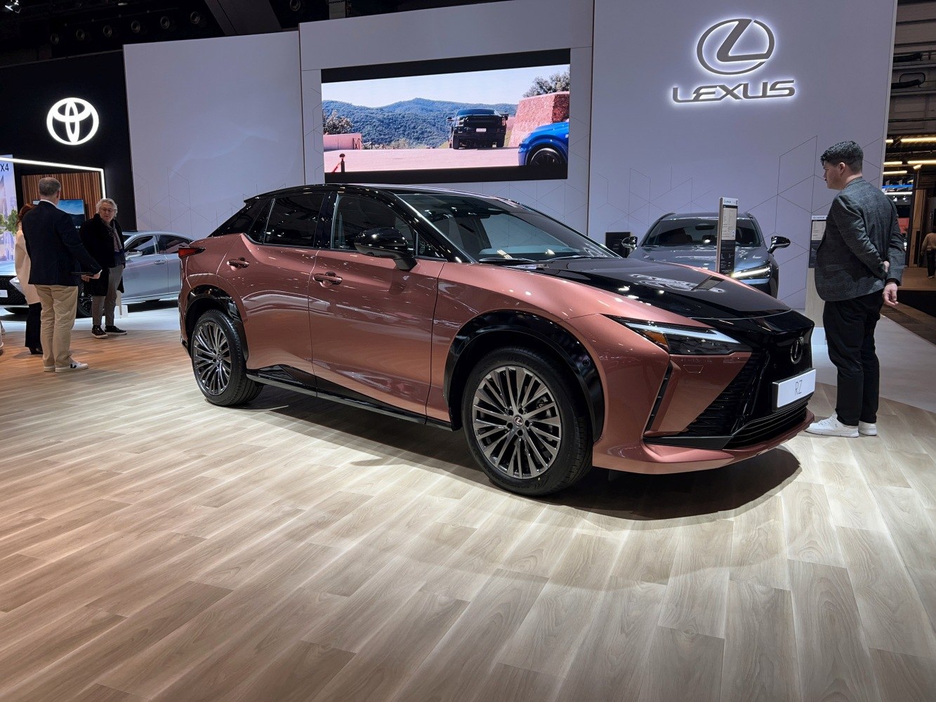 Front side view of an electric SUV with sharp LED headlights and distinctive grille