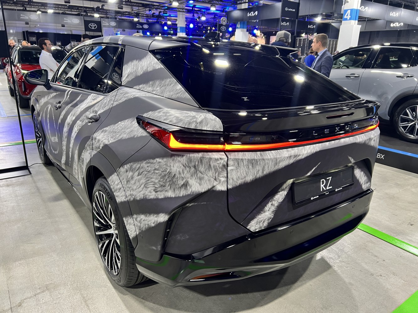 Rear view of a modern SUV with a continuous tail light strip and black roof.