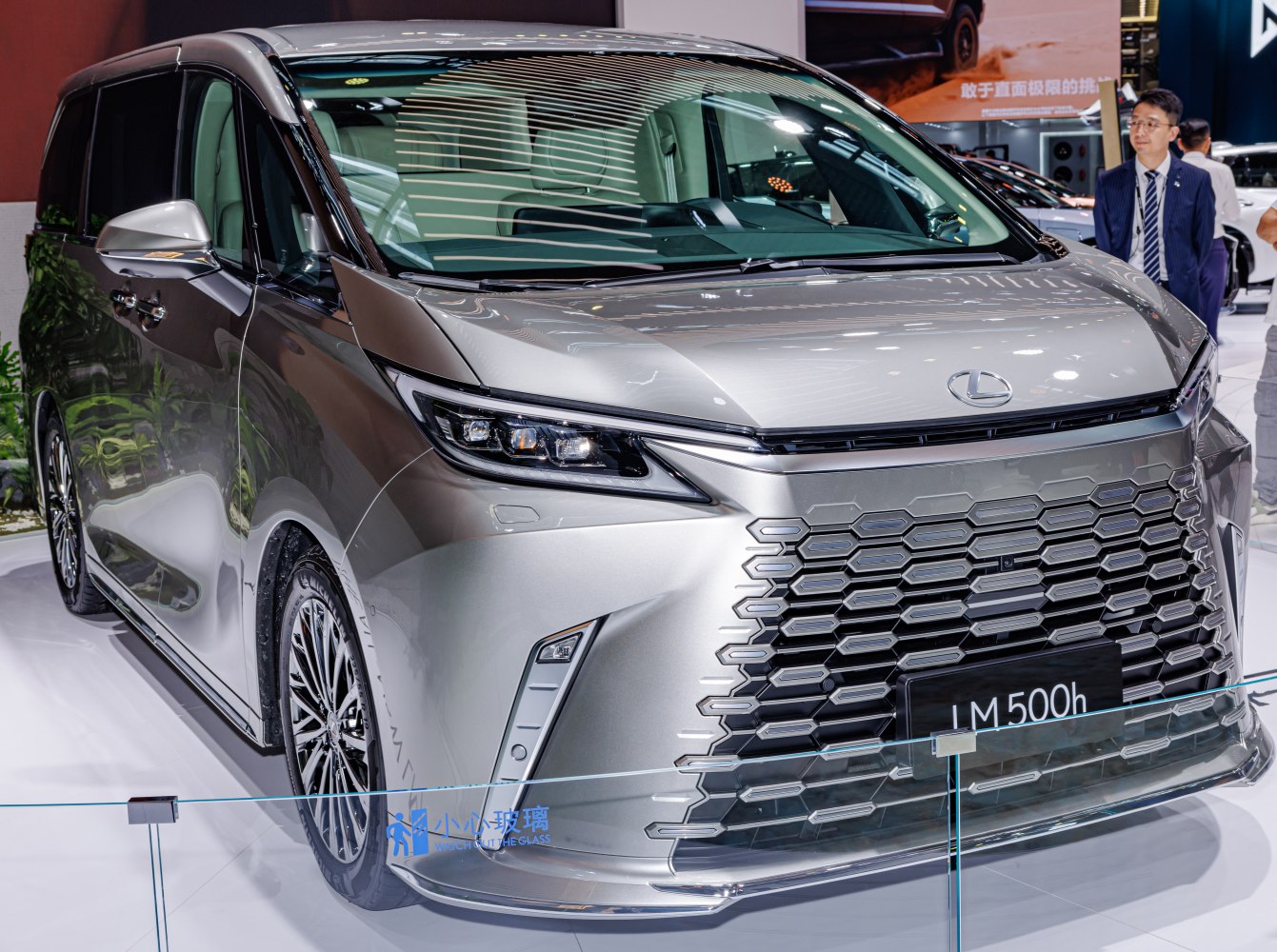 Prominent hexagonal grille with sleek LED headlights on a luxury minivan front.