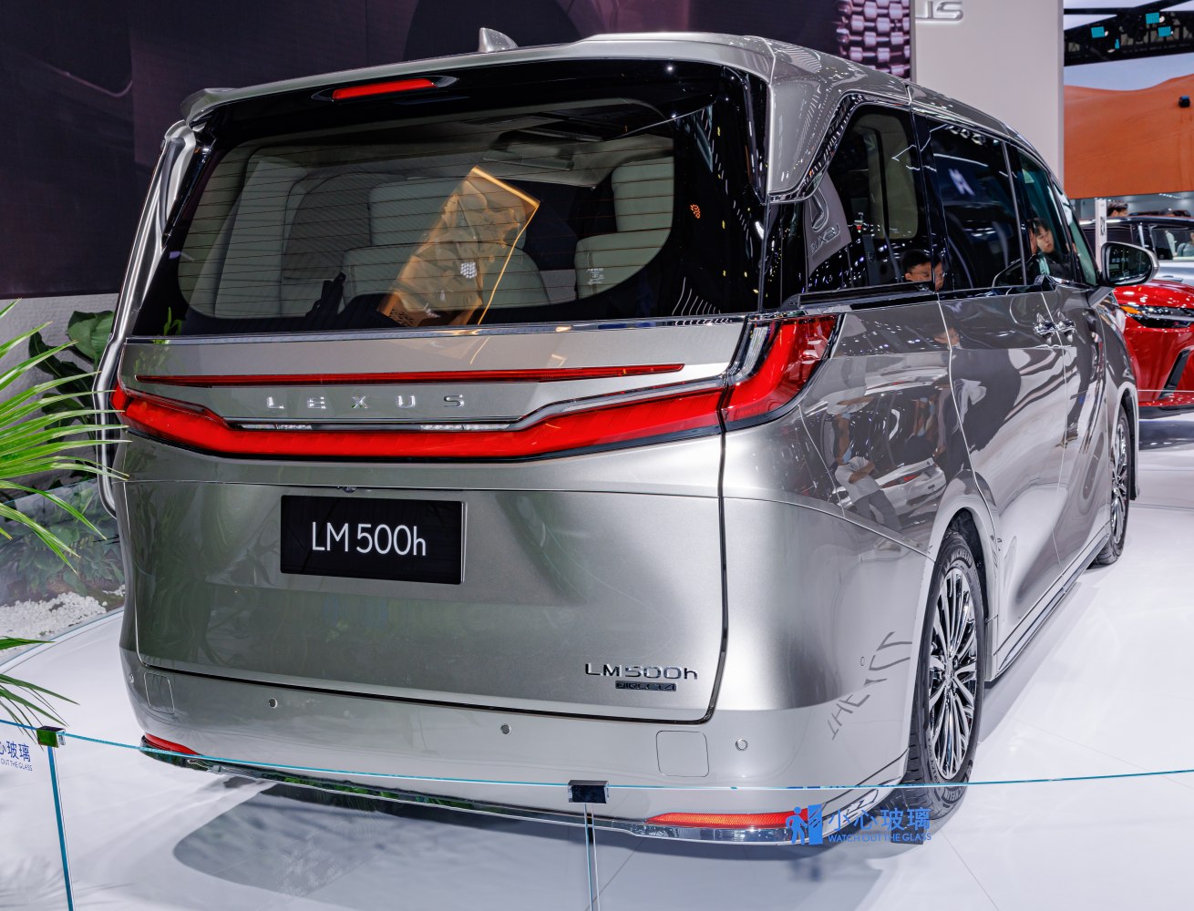 Rear view of a luxury minivan with integrated taillight design and sleek rear window.