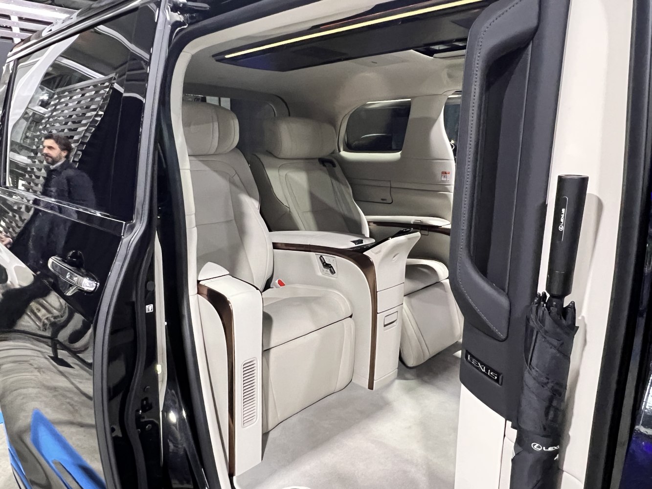 Premium spacious reclining seats with integrated controls and wood trim.