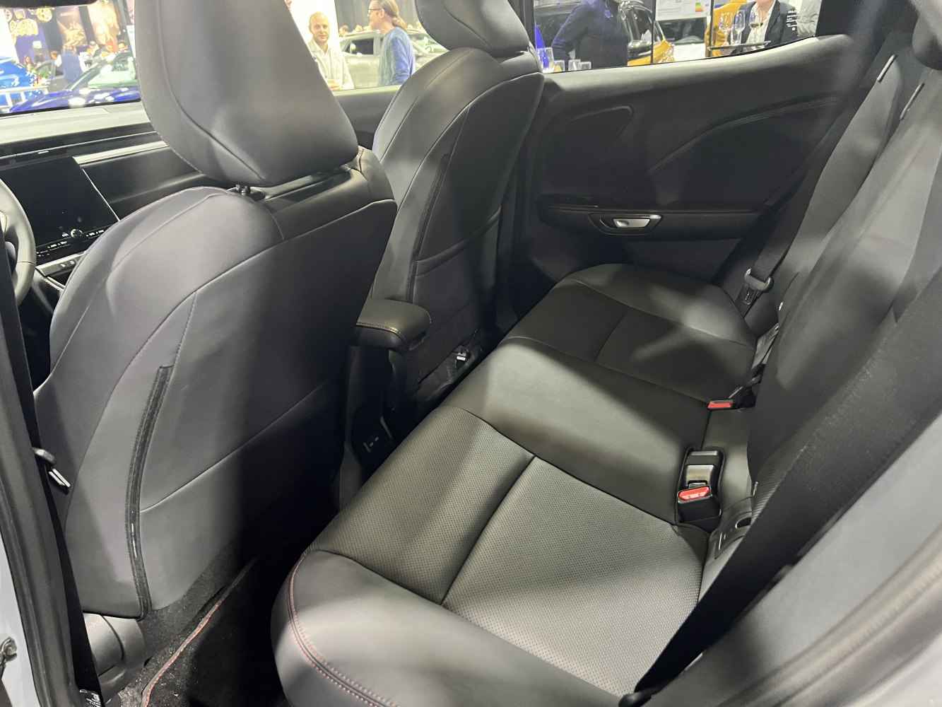Rear seating with black leather upholstery in compact car interior