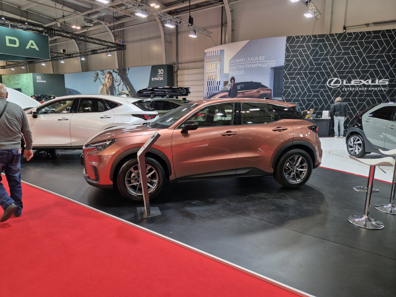 Side profile of a compact luxury SUV with aerodynamic curves.