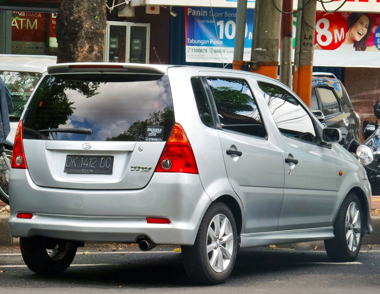 Rear side view of a silver hatchback with sporty design