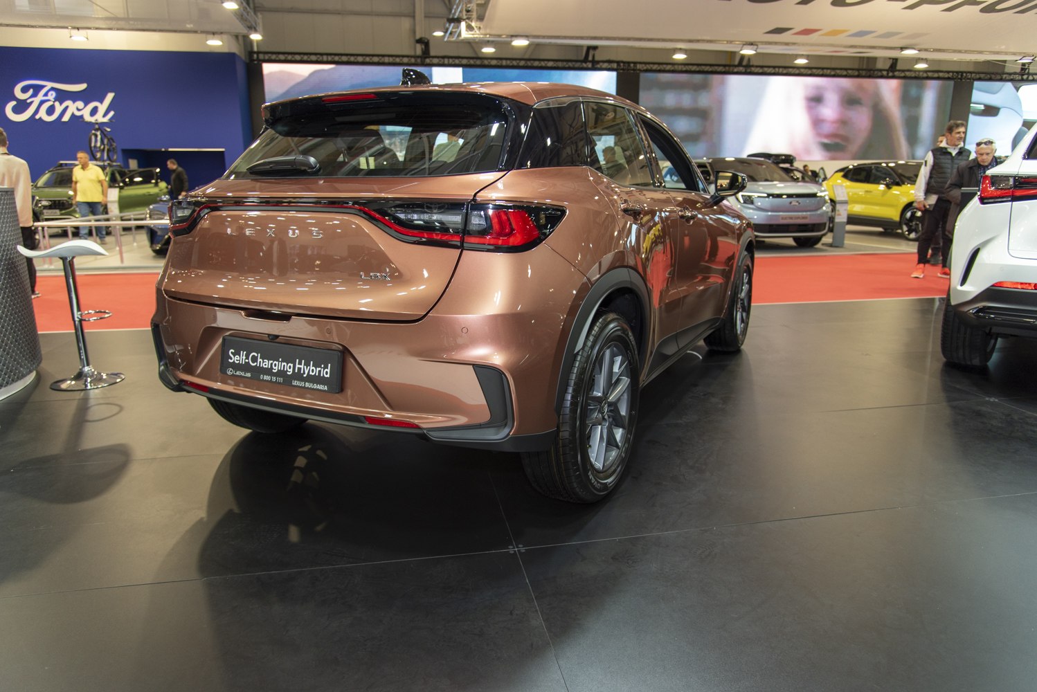 Rear view of a sleek hybrid SUV with distinctive tail lights and compact crossover design