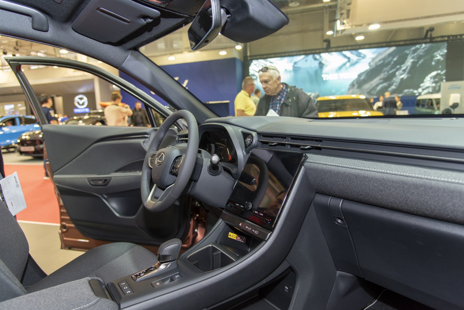 Dashboard layout and steering wheel with digital display and touchscreen infotainment.