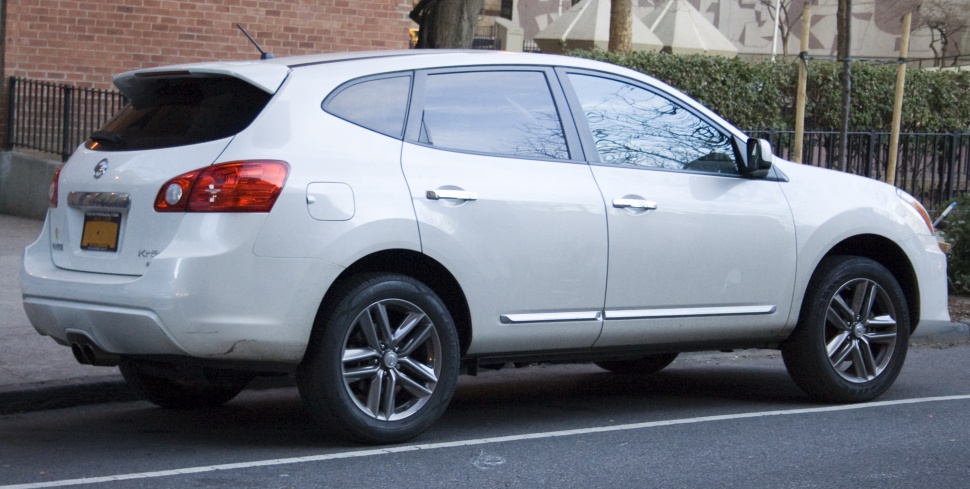 Rear side profile of a white SUV with alloy wheels and tinted windows
