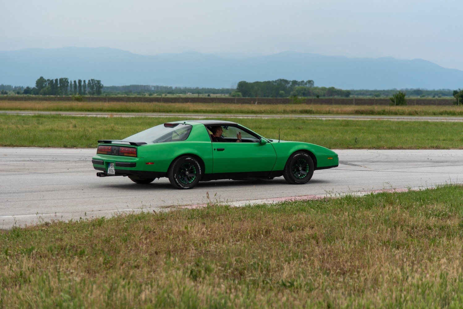 Classic sports coupe with rear spoiler and targa roof