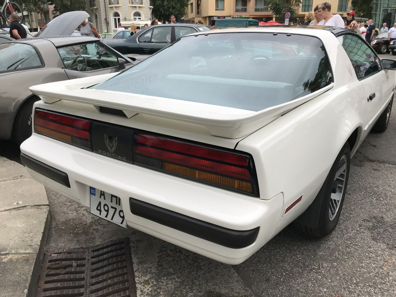 Rear view with taillights and spoiler of white muscle car