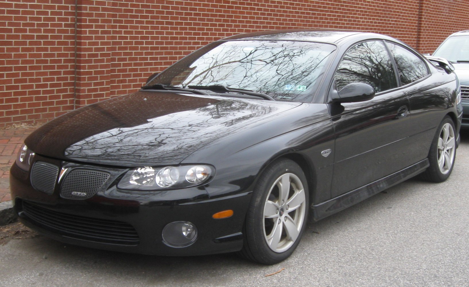 Front three-quarter view with split grille, headlights, and alloy wheels
