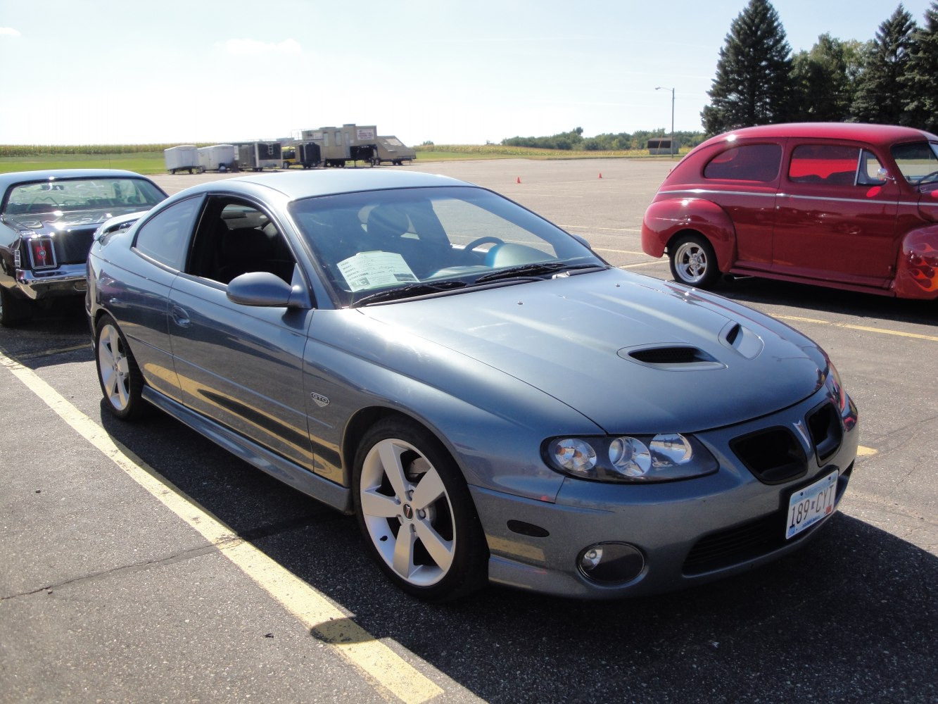 Front side view with hood scoop and five-spoke alloy wheels
