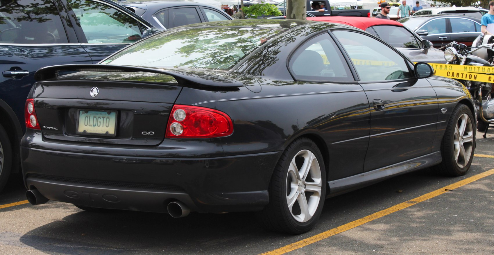 Black coupe rear with spoiler and dual exhaust