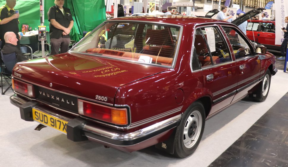 Rear and side view of a vintage sedan with distinctive taillights and badges