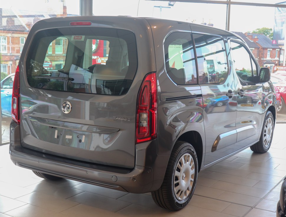 Rear hatch and side profile of a compact MPV with prominent taillights and large windows