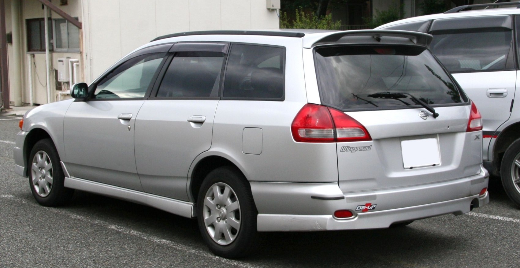 Silver station wagon with rear spoiler and roof rails