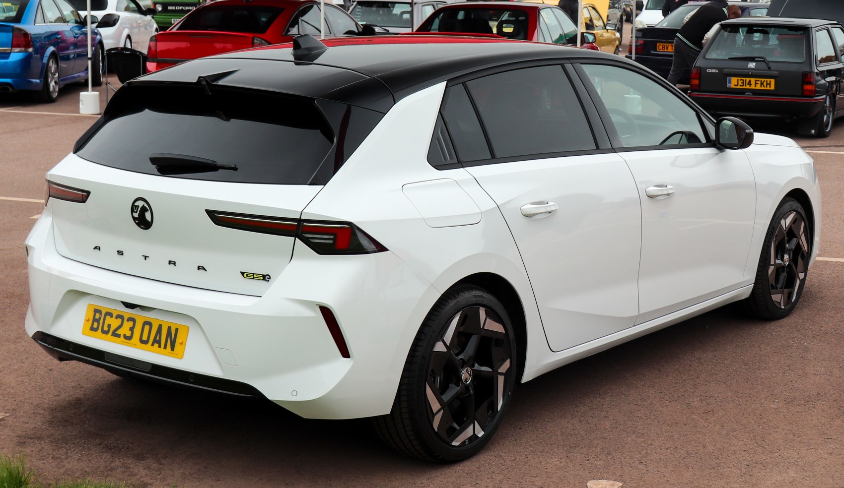 Rear three-quarter view with black roof and sleek taillights