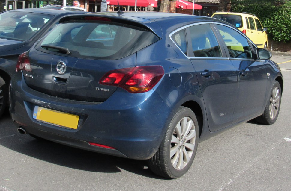 Rear view of hatchback with distinctive taillights and single exhaust