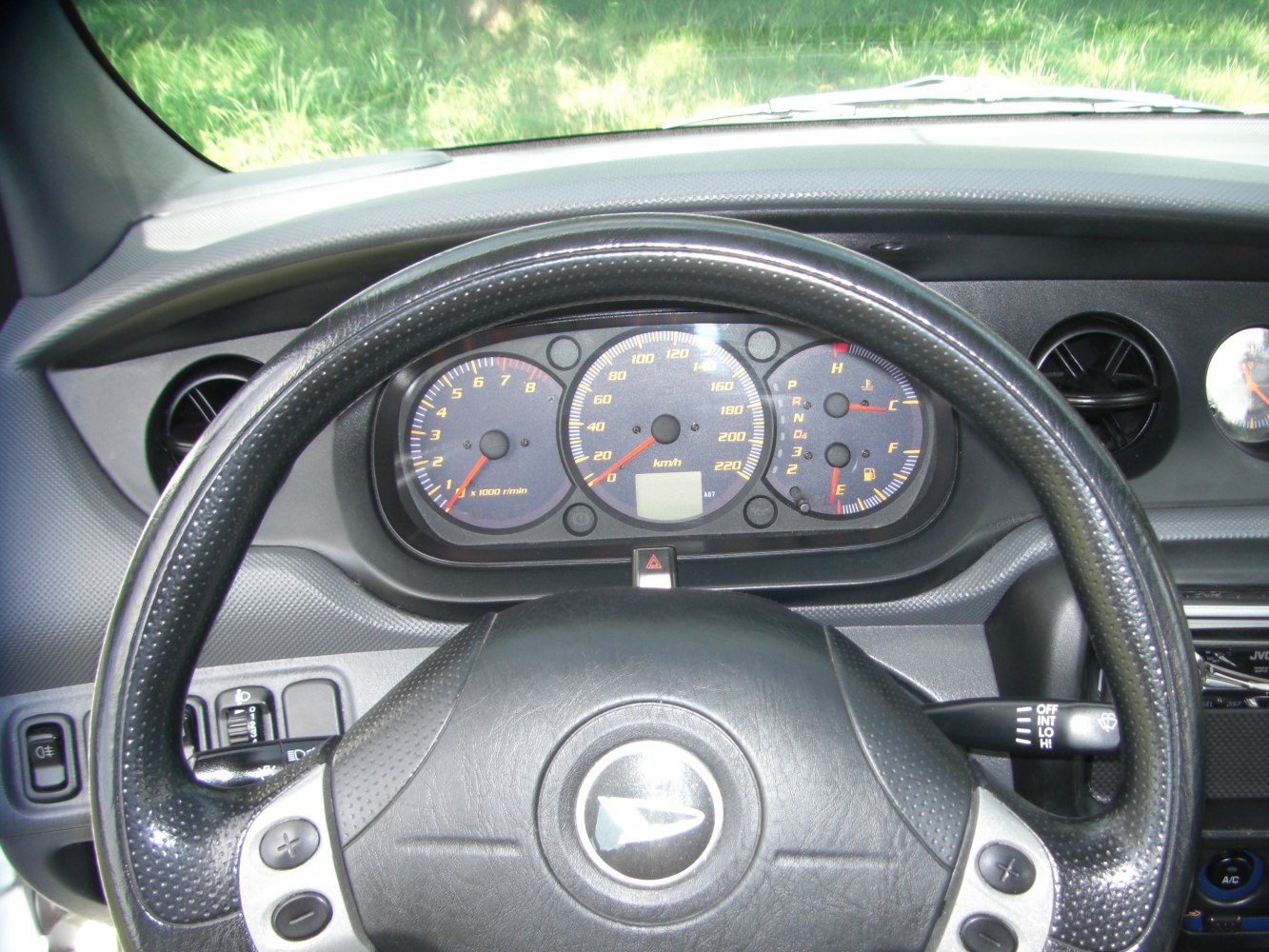 Close-up of dashboard and steering wheel with instrument cluster