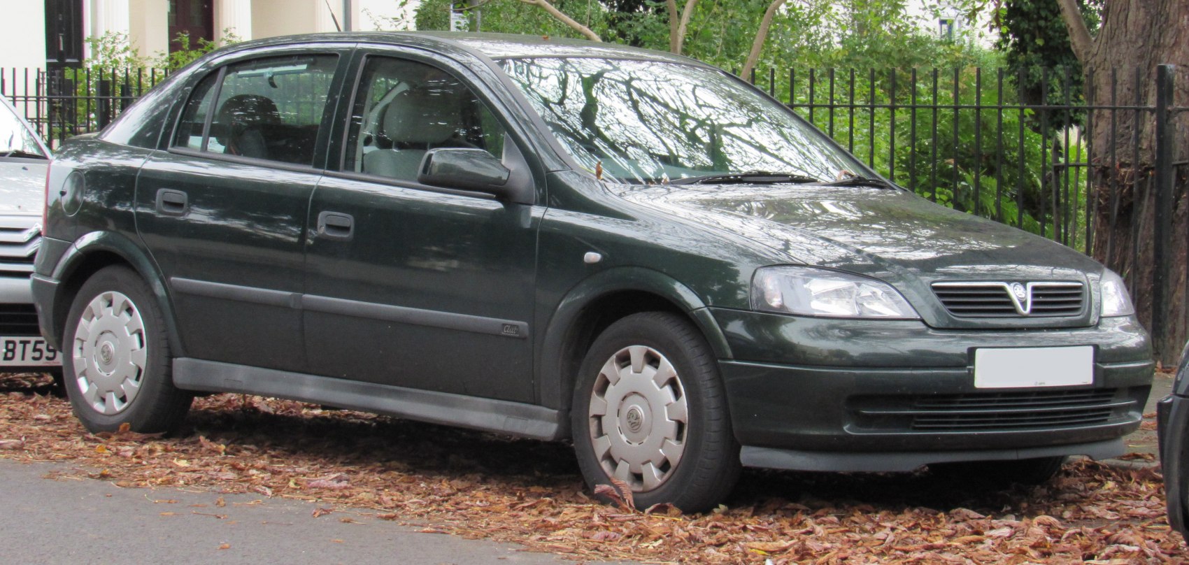 Side profile and front view of a sedan with distinct hubcaps